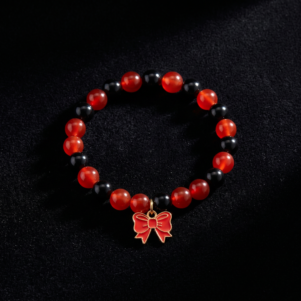 Handmade Red and Black Crystal Glass Bead Stretch Bracelet with Gold Enamel Bow Charm