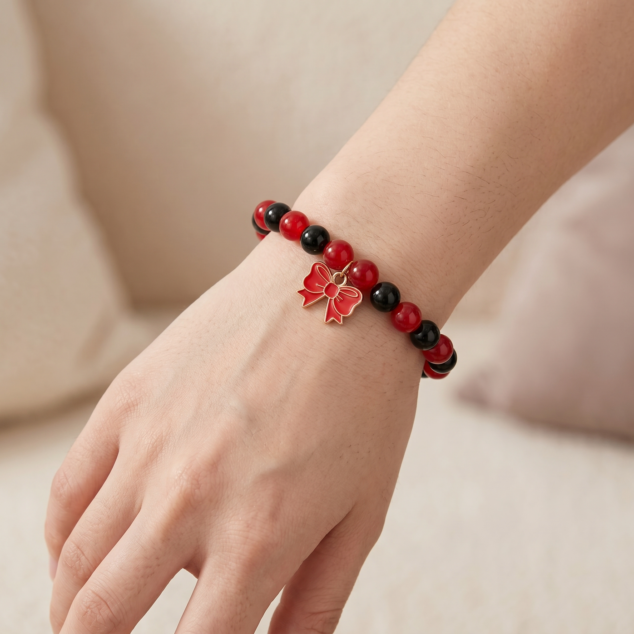 Handmade Red and Black Crystal Glass Bead Stretch Bracelet with Gold Enamel Bow Charm