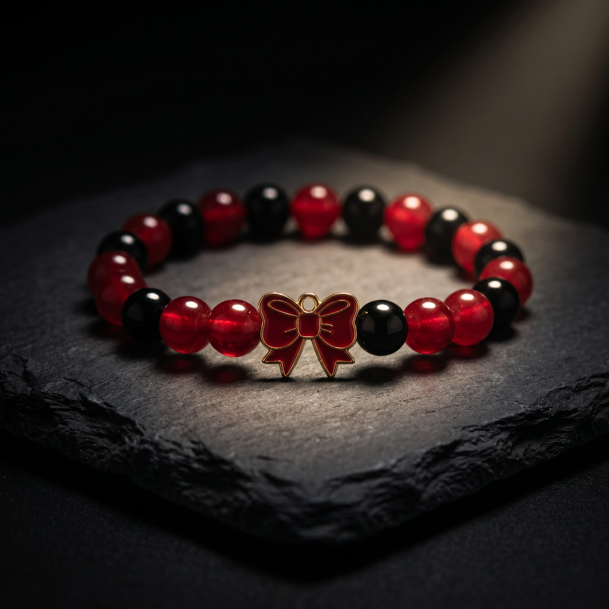 Handmade Red and Black Crystal Glass Bead Stretch Bracelet with Gold Enamel Bow Charm
